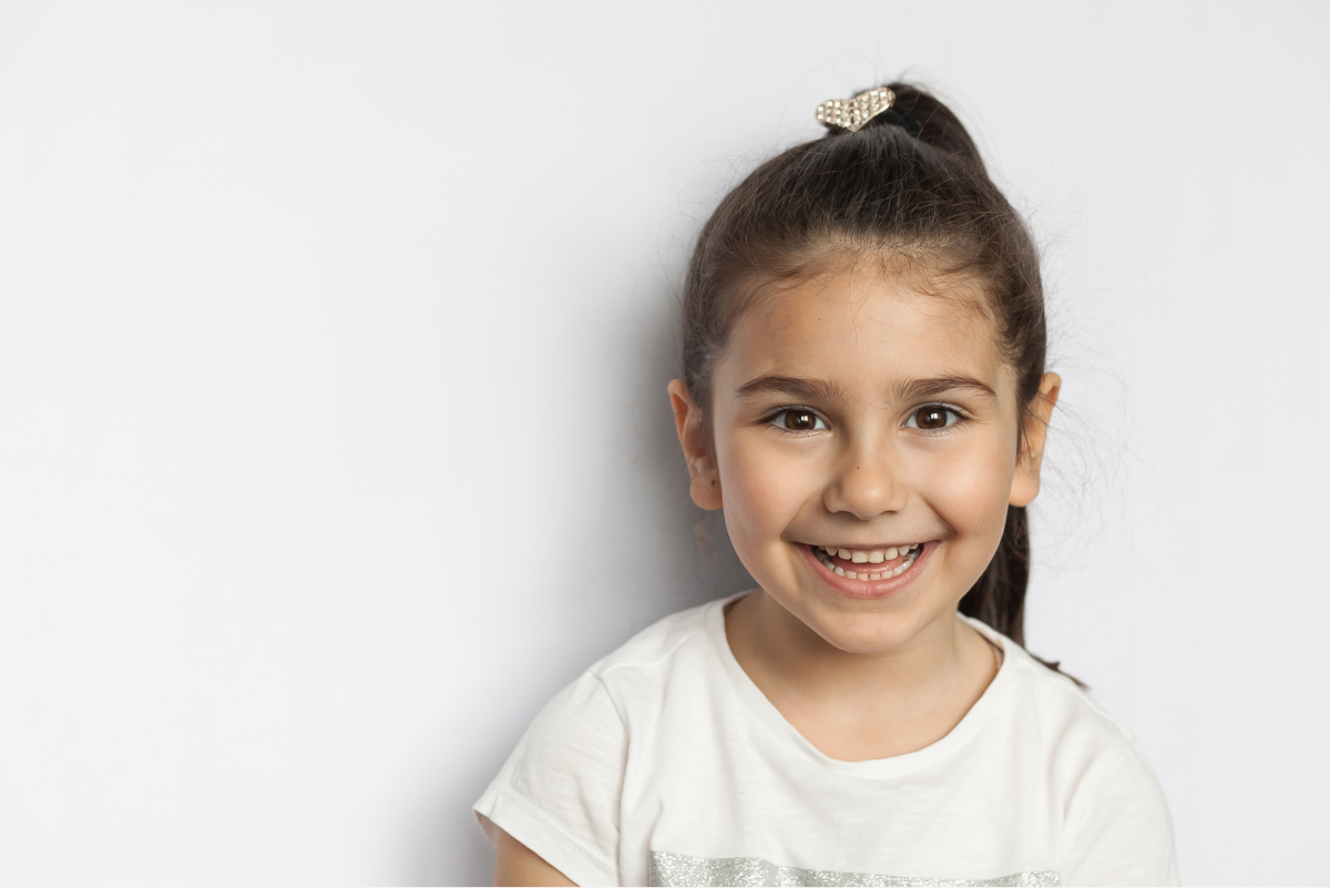 Young girl with a bright smile ready for her orthodontic visit