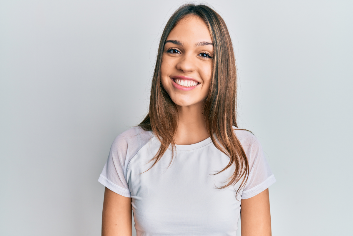 Young woman with a beautiful smile after orthodontic treatment